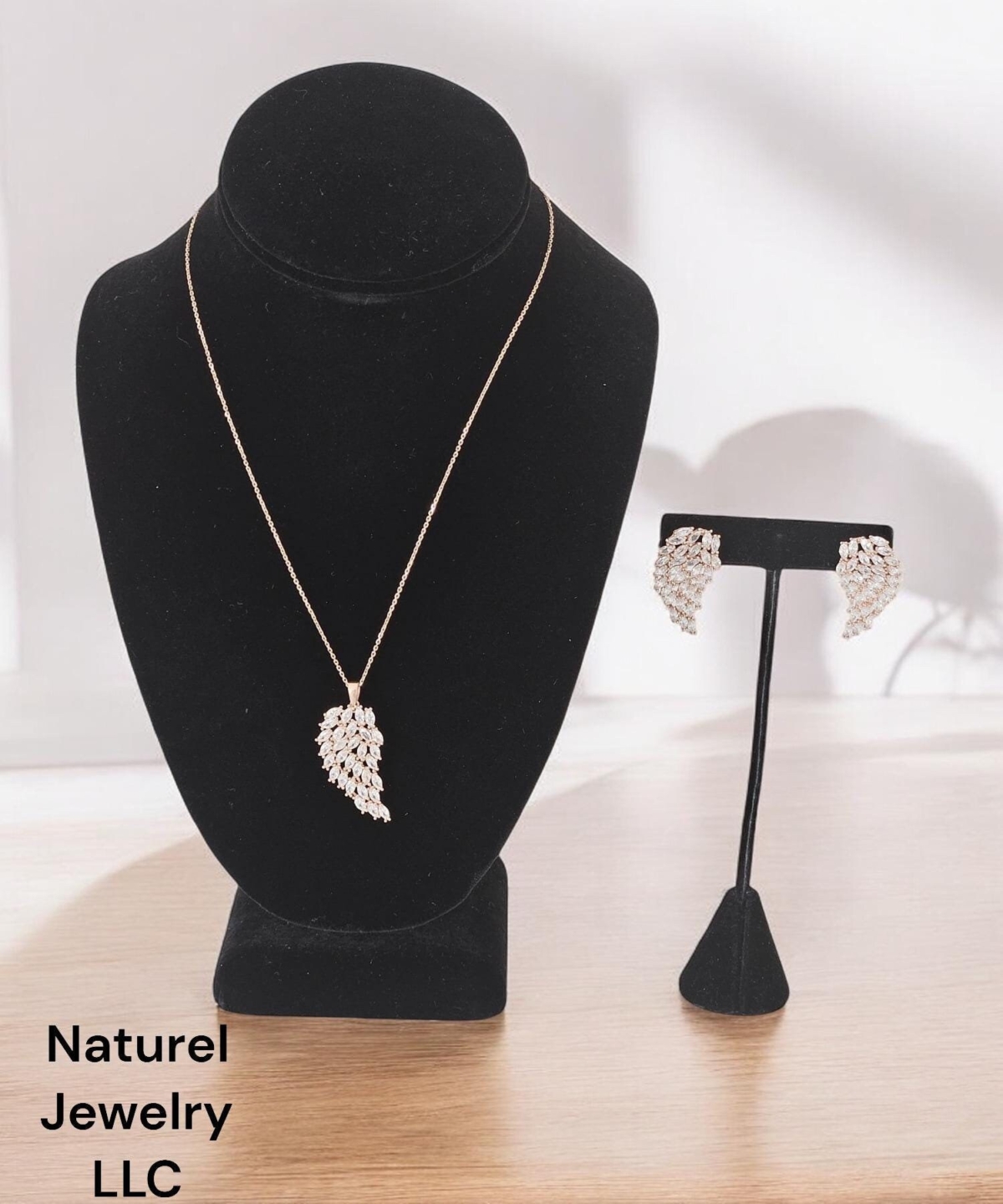 Leaf shape Rose Earring and Necklace with Leaf Pendant covered with white zircon. Both pendant ,necklace and earring color is rose gold.